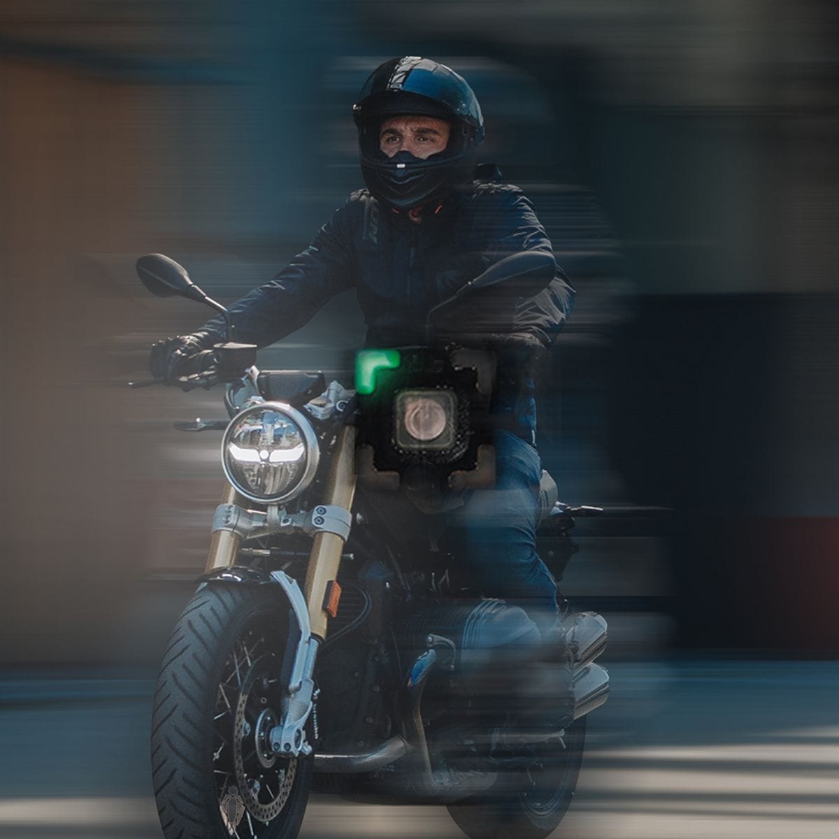 Motorcyclist in black gear speeds on a modern motorcycle with blurred background.